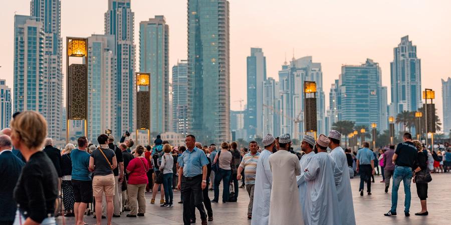Crowds on the Downtown Dubai boulevard with the Downtown towers behind